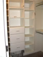 This master bedroom has custom built closet shelves and drawers, which provide extra storage space 